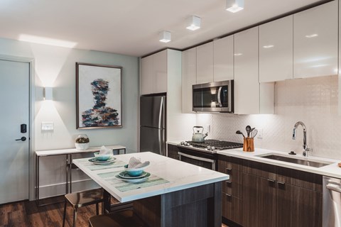 a kitchen with white cabinetry and a large island with a white countertop